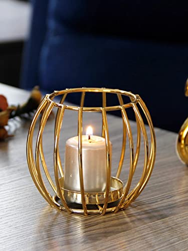 A candle glowing inside a fancy gold bird cage