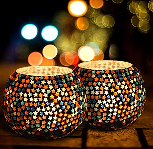 Colorful glass tealights contrast with black background.