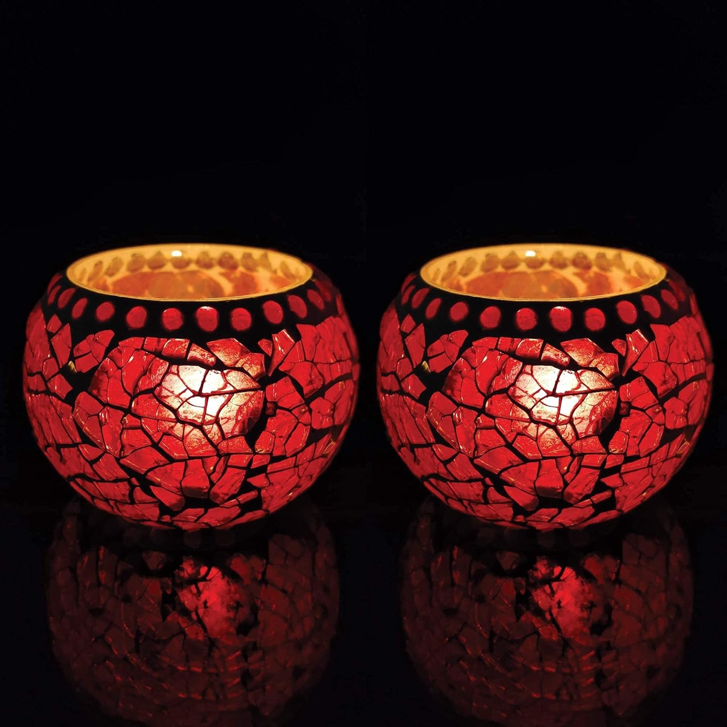 Red glass tealights shining brightly on a table