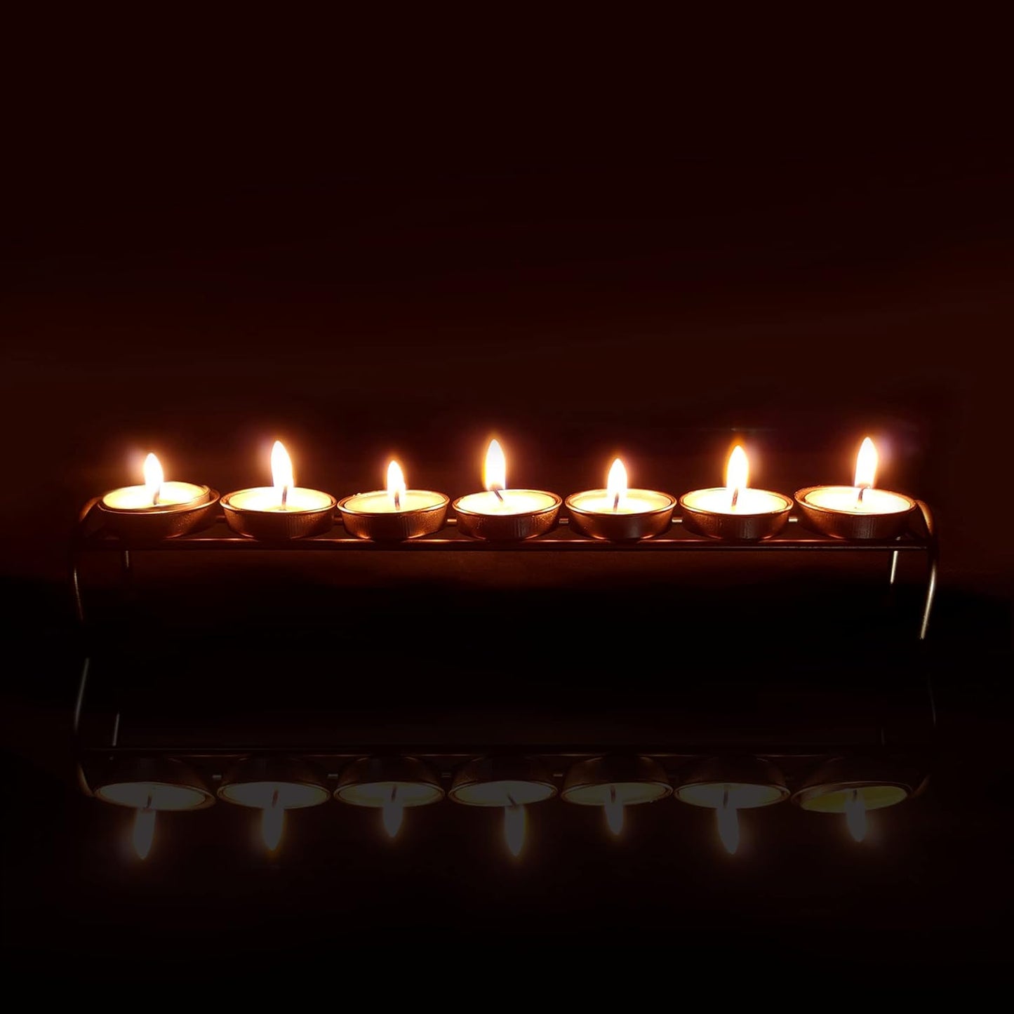 Candles aglow on a metal candlestick.