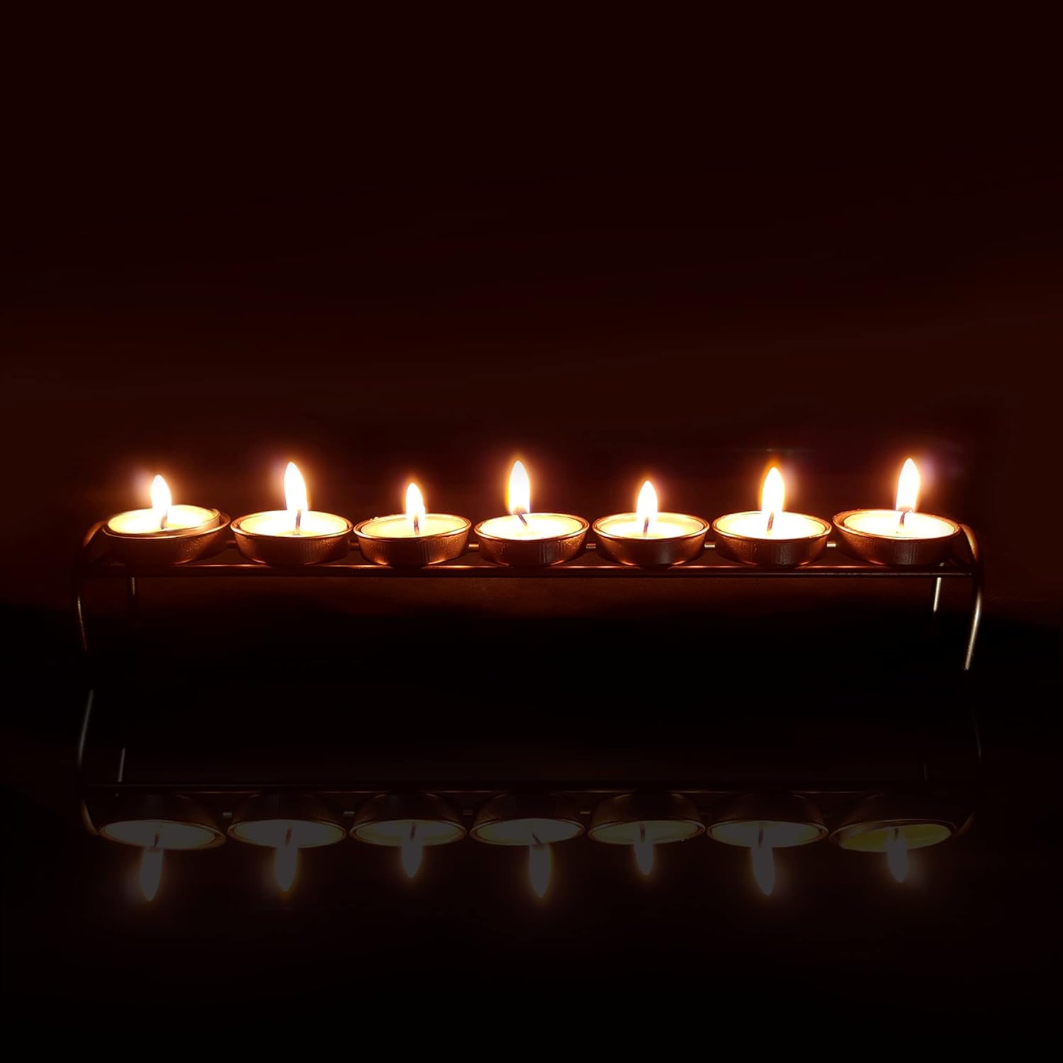 Candles aglow on a metal candlestick.