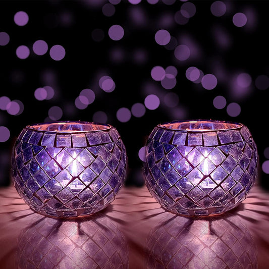Purple glass tealights resting on table with purple background.