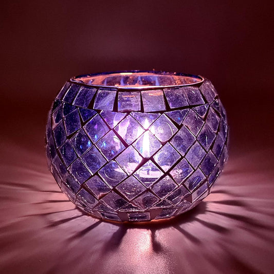Glowing tealight holder made of purple glass.