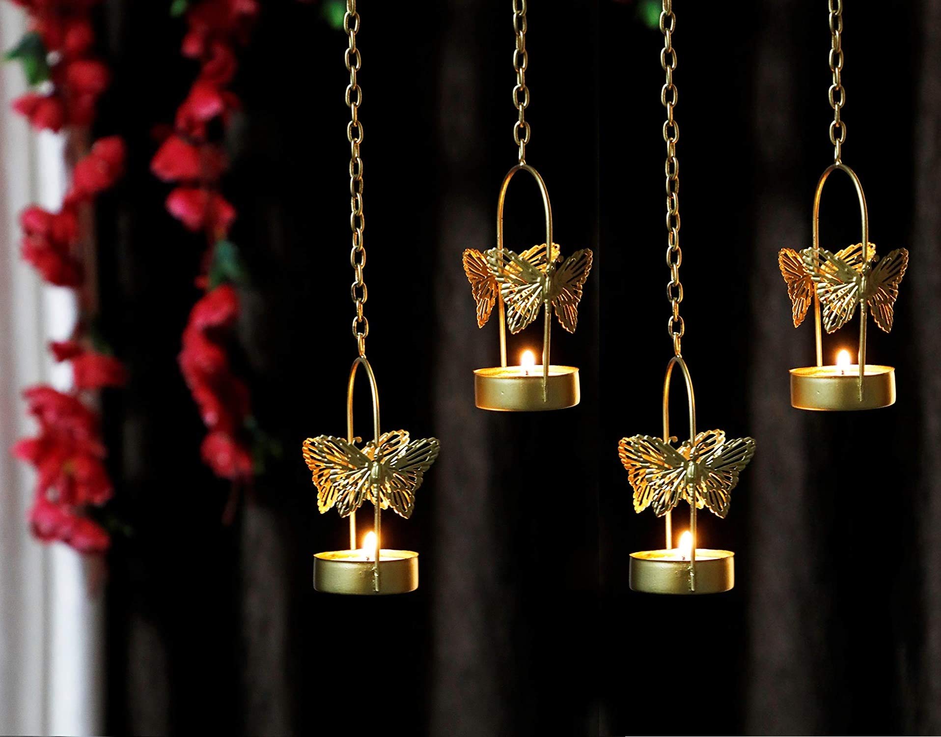Two tealights with butterfly designs hanging in the air, casting a warm and inviting glow.