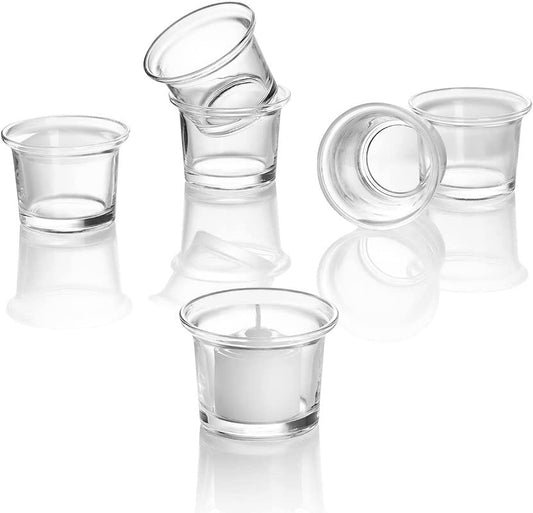 Transparent cups with candles burning inside.