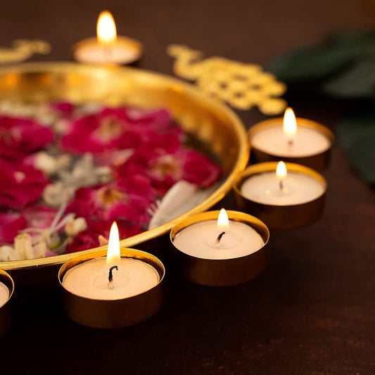 Elegant gold plate featuring beautiful flowers and glowing candles.