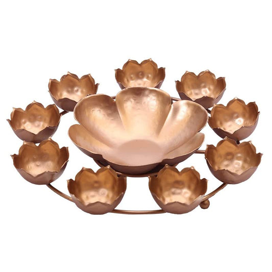 Traditional Diwali lamp with gold and silver floral decorations.