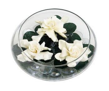 Seashells and candles elegantly displayed in a bowl, adding a touch of seaside charm.