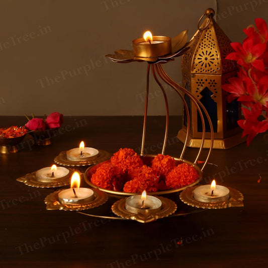 Gold candle holder with lovely flowers and candles, adding a touch of sophistication to any space.