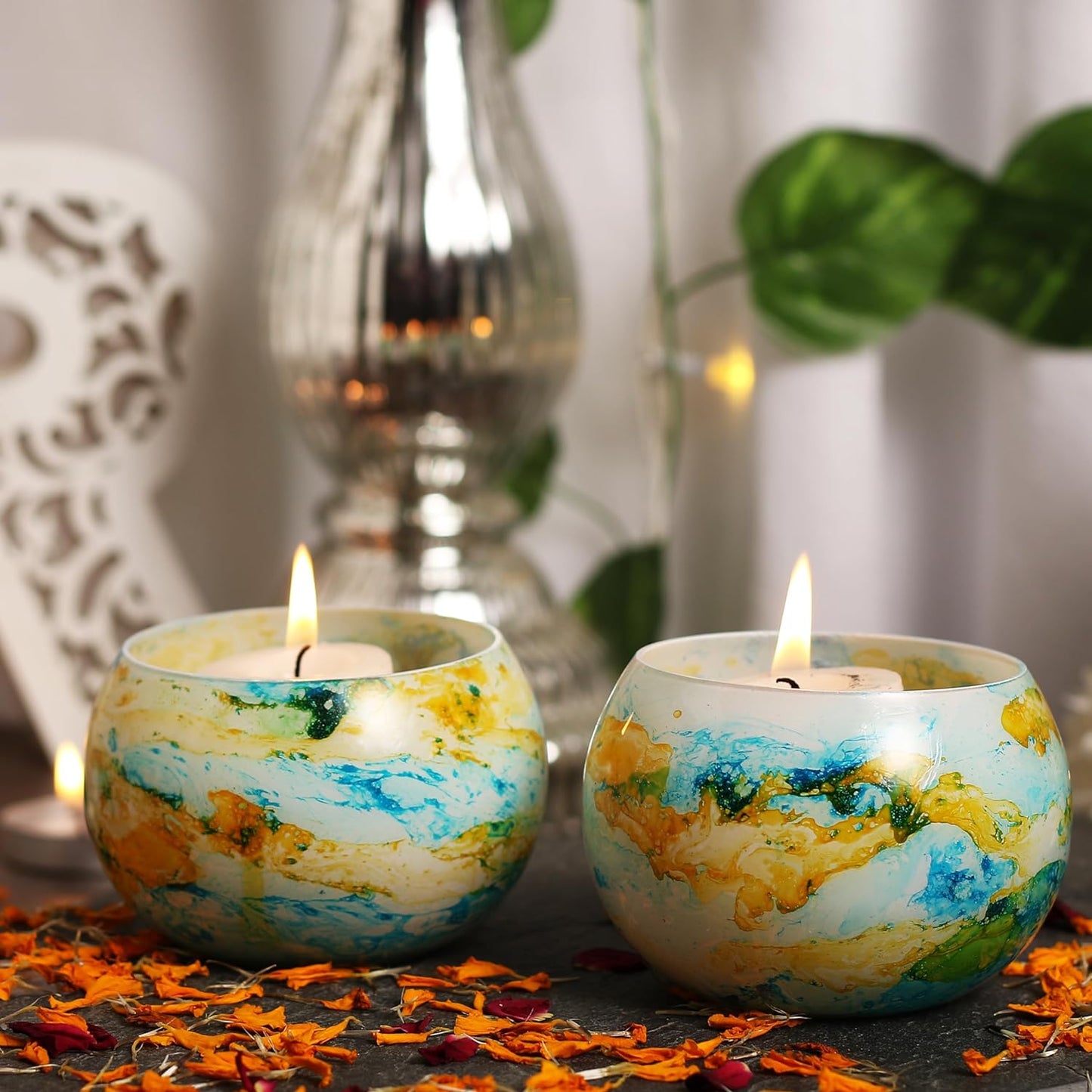 Candles featuring intricate yellow and blue designs, adding a touch of elegance to your decor.
