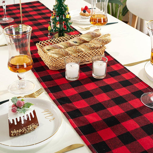 A table adorned with a red and black plaid tablecloth, adding a warm and inviting touch to the setting.