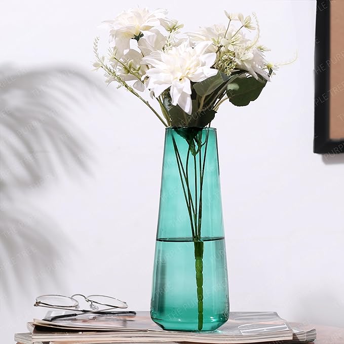 Flowers arranged in a green vase on a table