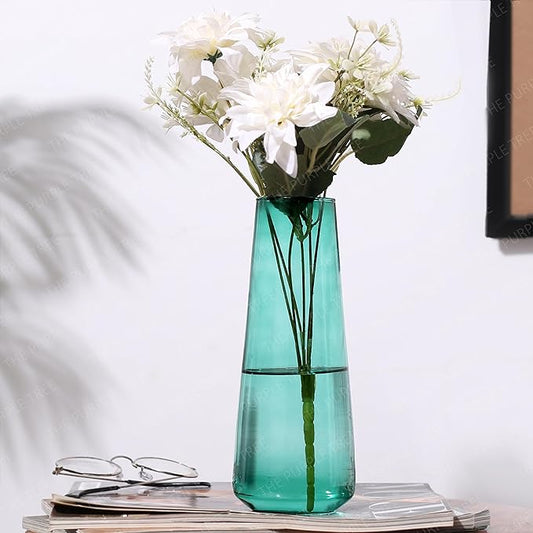 Flowers arranged in a green vase on a table