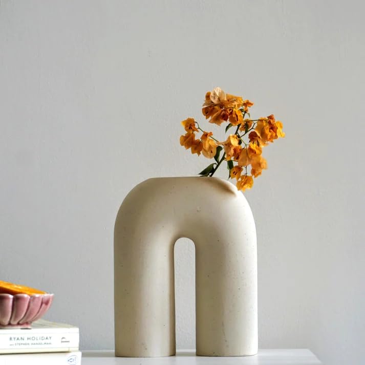 White vase adorned with a colorful flower