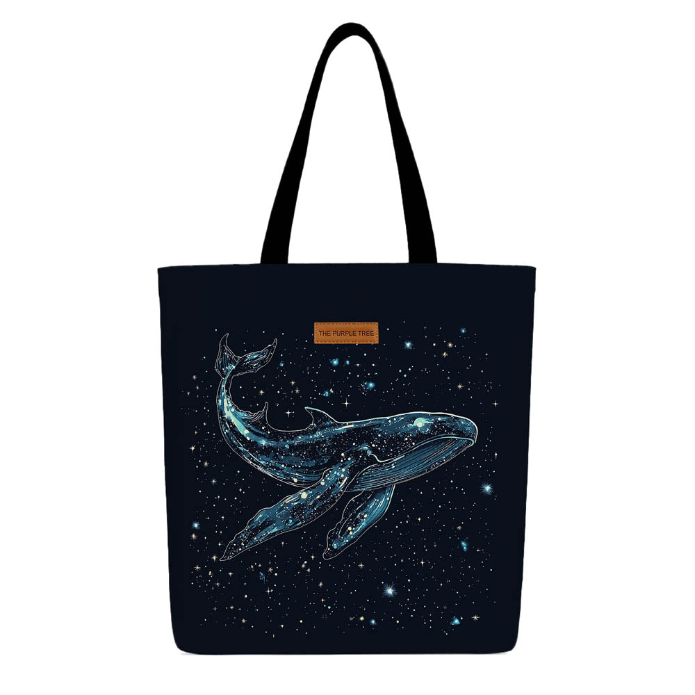 A tote bag featuring a whale design surrounded by stars on a light background.