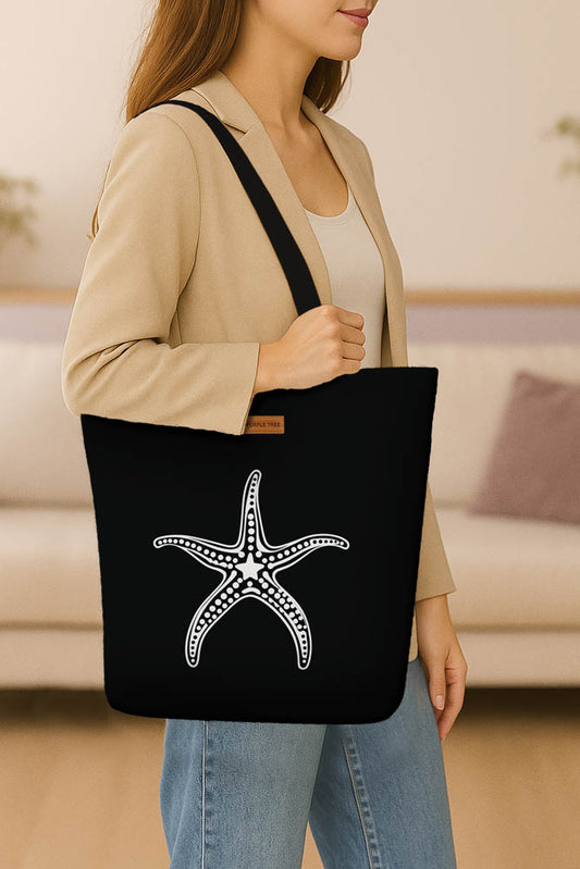 A stylish black tote bag adorned with a starfish motif, perfect for carrying essentials.