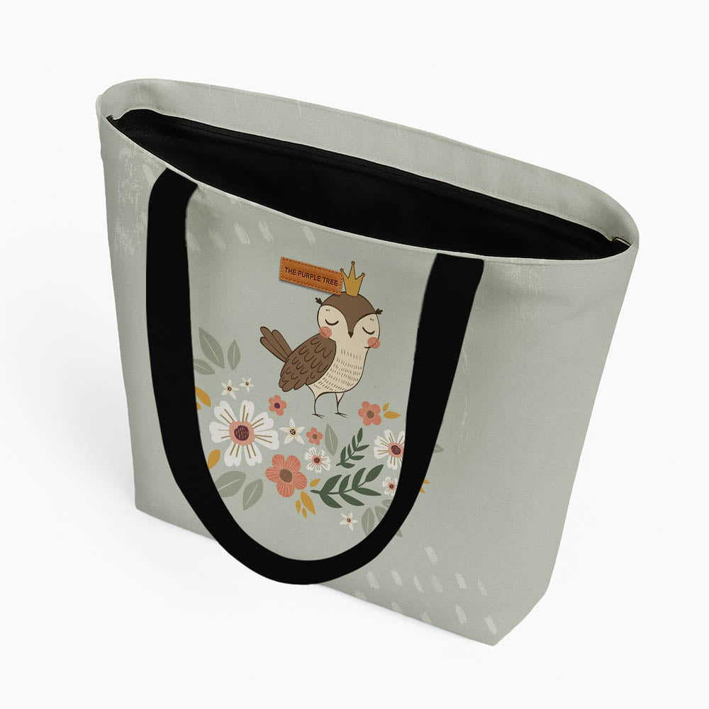 A tote bag displaying an owl nestled among flowers, combining nature and art in a charming design.