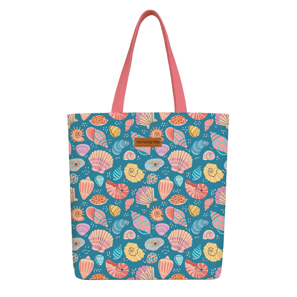 A blue tote bag adorned with vibrant, colorful shell patterns.