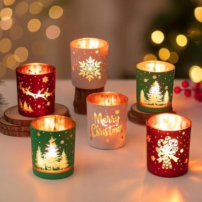 Decorative candles holders with Christmas designs on a snowy surface