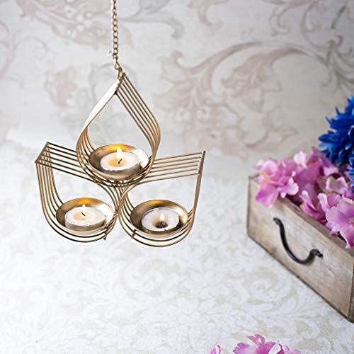 Decorative gold hanging lamp with three candle holders on a dark background