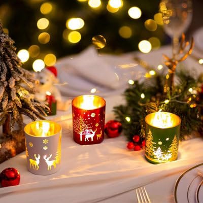 Decorative candles with Christmas designs on a snowy surface