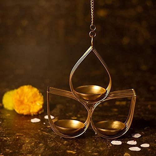 Decorative gold hanging lamp with three candle holders on a dark background
