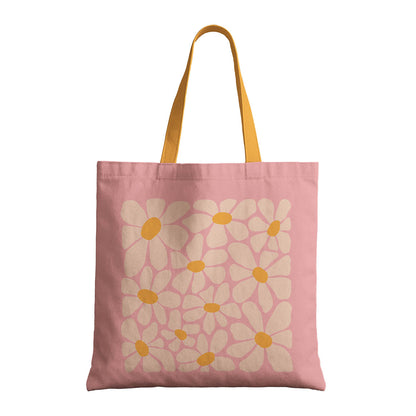 A pink tote bag with flowers design and yellow handles, combining functionality with a playful color scheme