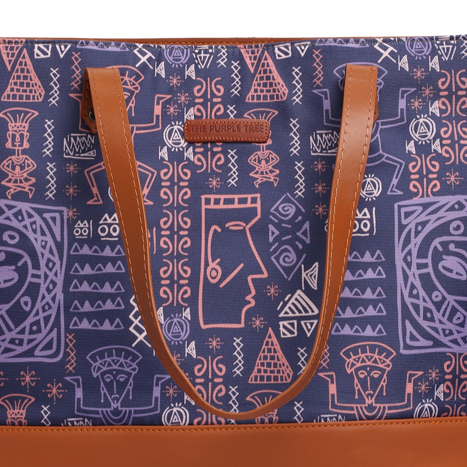 A stylish purple and brown tote bag resting on a chair.