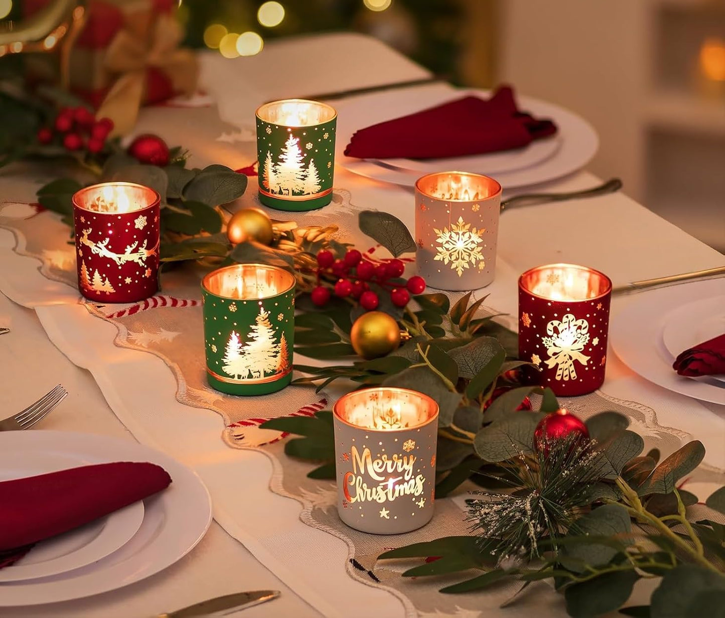 Decorative Christmas table setting with lit candles and festive decorations.