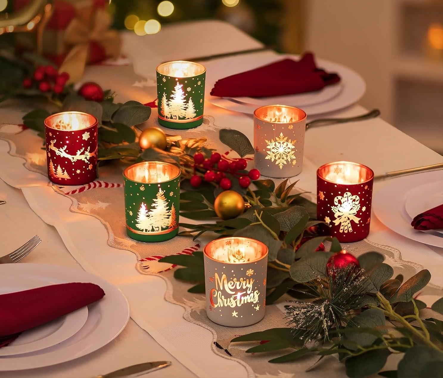 Decorative Christmas table setting with lit candles and festive decorations.