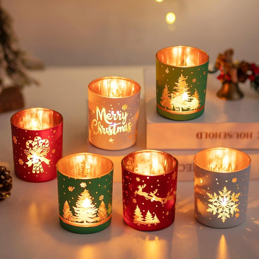 Decorative candles holders with Christmas designs on a snowy surface