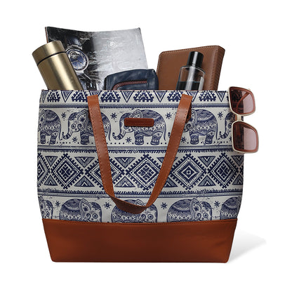 Leather elephant print tote bag with brown handle.