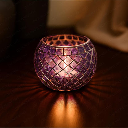 Decorative purple candle holder with a warm glow on a dark surface