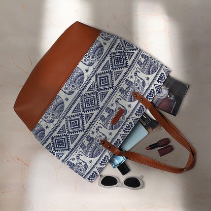 Elephant print leather tote bag with stylish brown handle.