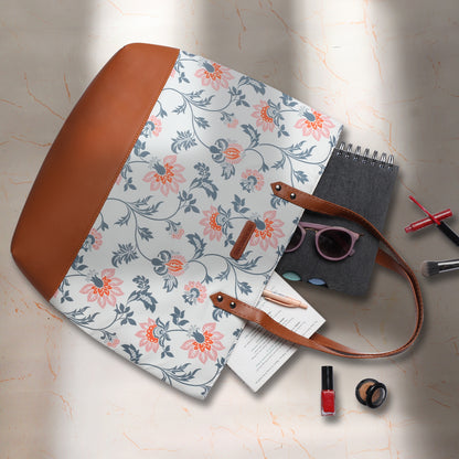 Floral tote bag resting on a chair, adding a touch of elegance to the room's decor.