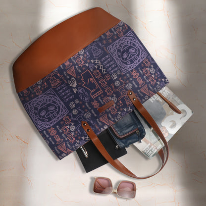 Chic tote bag in purple and brown color scheme on a chair.