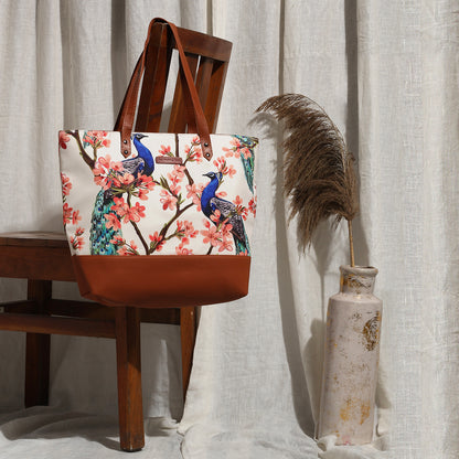 A stylish tote bag featuring colorful birds in flight, perfect for carrying essentials on the go.