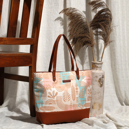 Light blue and pink patterned tote bag, perfect for carrying essentials in style.