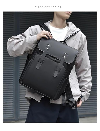 A sleek black backpack with two adjustable straps and a durable leather handle on top.