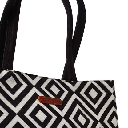 Elegant bag with a book and a glass of water, in classic black and white design.