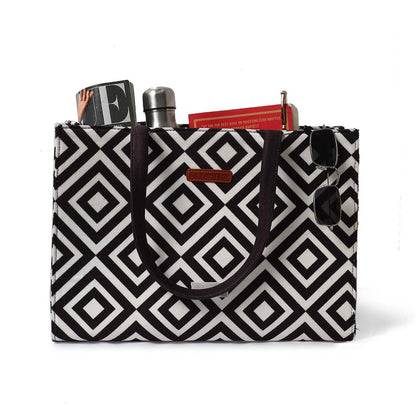 A chic bag with a book and a glass of water, all in a stylish black and white pattern. So fashionable!