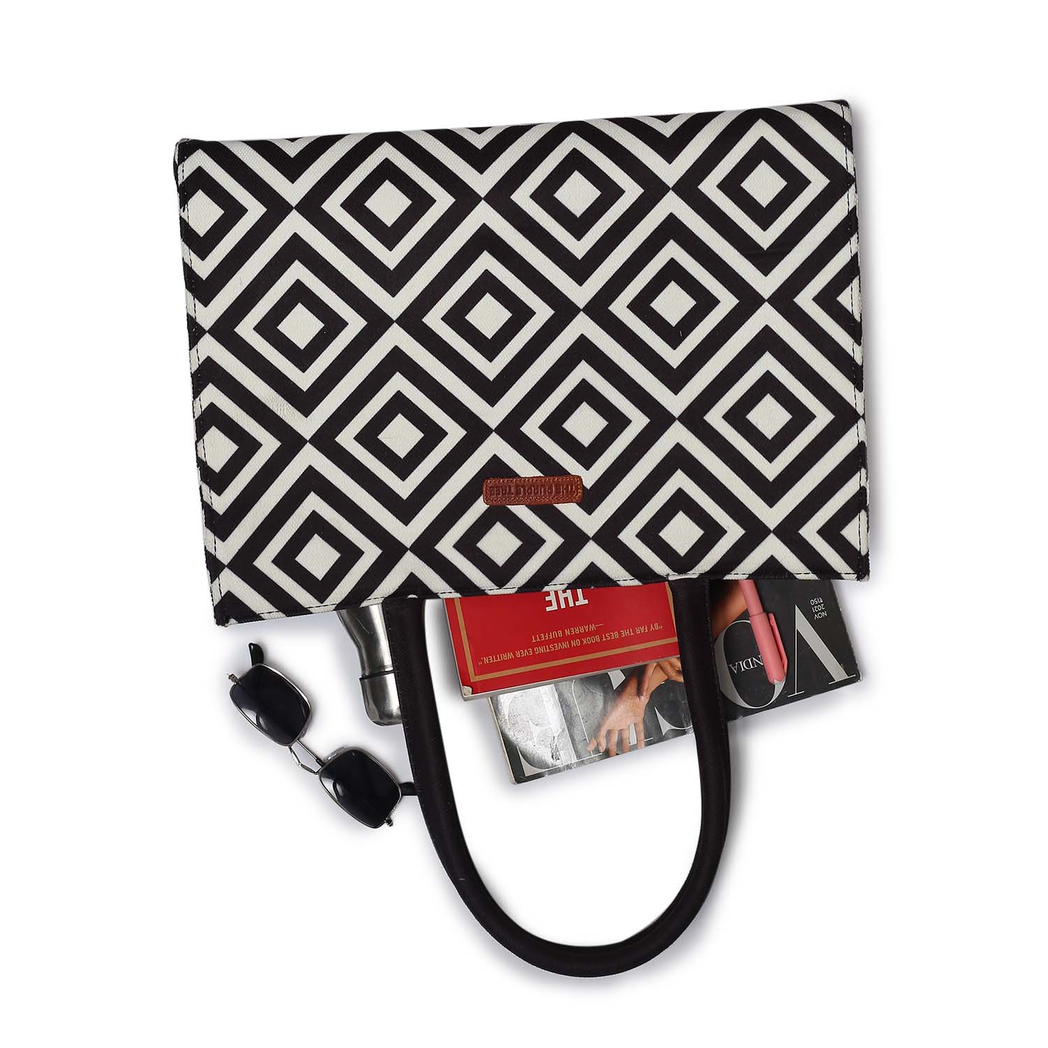  Look at this fabulous bag! It's adorned with a black and white pattern and comes with a book and a glass of water.