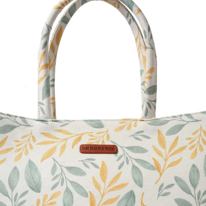 Tote bag with a trendy yellow and green leaf pattern, ideal for everyday use.