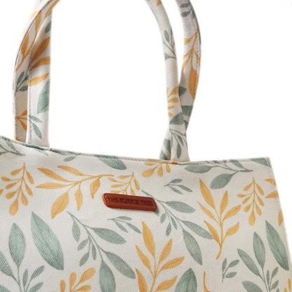 Eye-catching tote bag with a beautiful yellow and green leaf print.