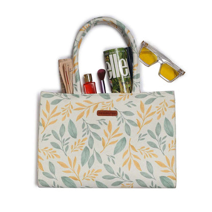 Yellow and green leaf print tote bag, perfect for carrying essentials in style.