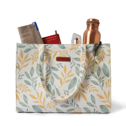 A stylish tote bag with a vibrant yellow and green leaf print. Perfect for adding a pop of color to any outfit!