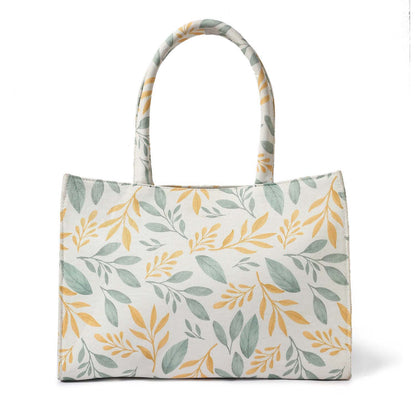 Fashionable tote bag adorned with a yellow and green leaf print.