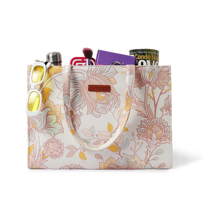 Stay trendy with this white and yellow floral print tote bag.