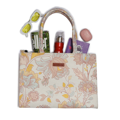  Fashionable tote bag adorned with white and yellow floral print, a must-have accessory.