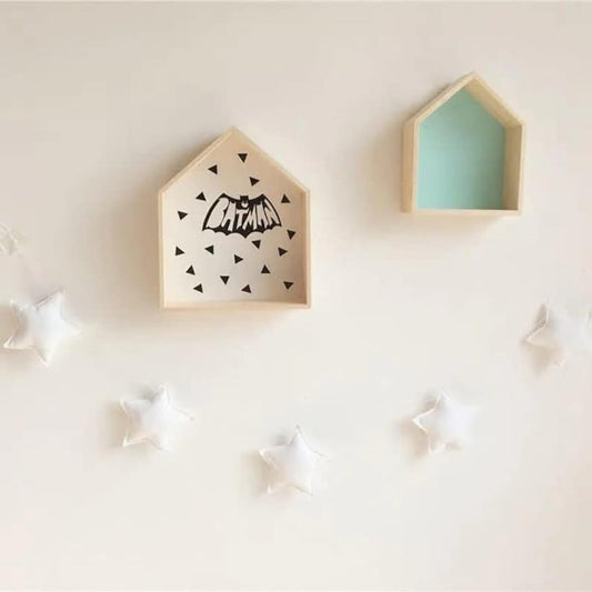 Two cozy wooden houses with star decorations on the wall, creating a warm and inviting atmosphere.